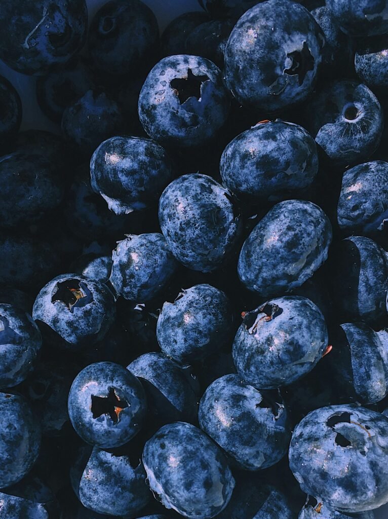 A vibrant close-up of a heap of fresh, juicy blueberries, showcasing their natural beauty and nutritional appeal.